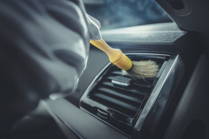 Car vents cleaning with a brush
