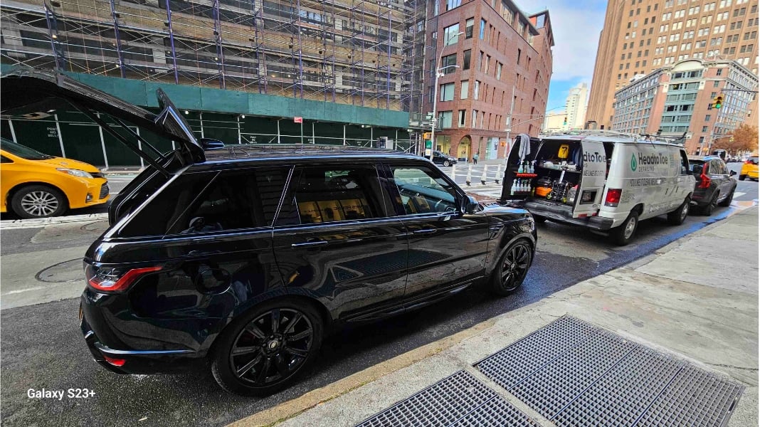 Side of Range Rover Sport with open trunk after detailing